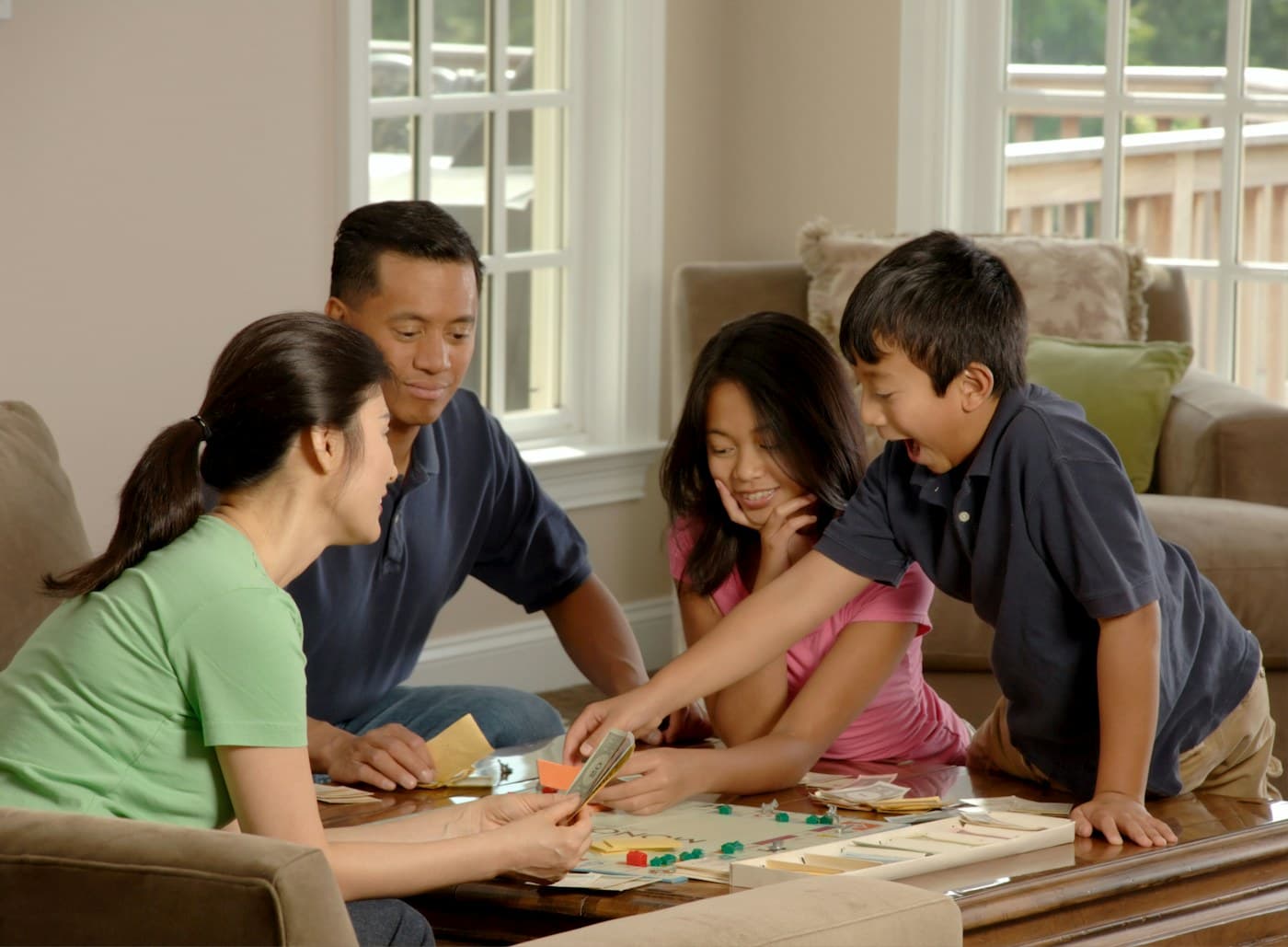 A family gathered around a board game, spending time together.